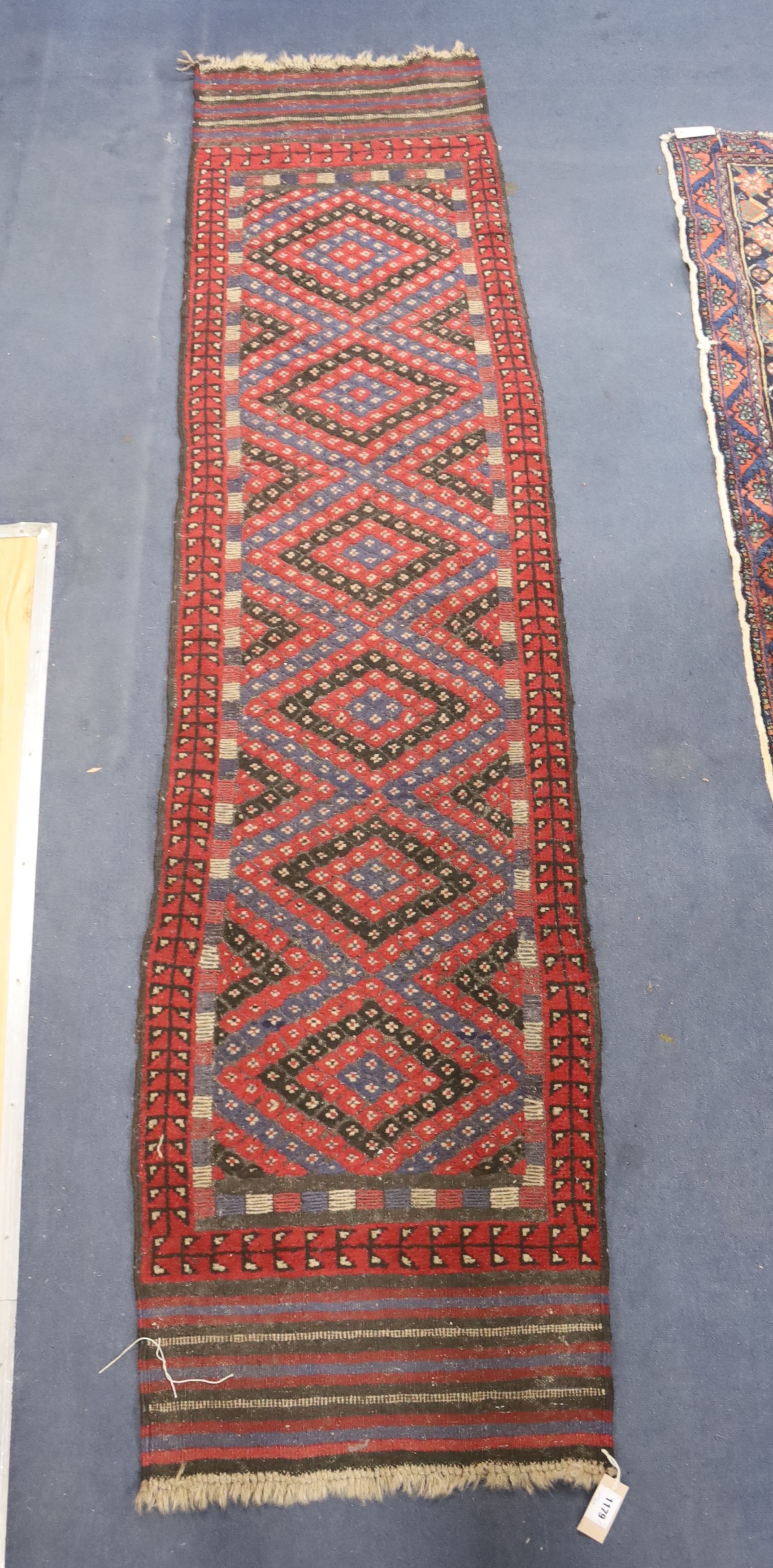 A Kelim polychrome geometric runner, 240 x 59cm